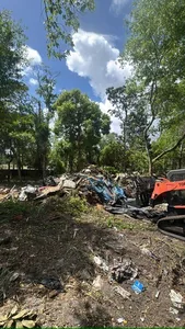 Champs equipment clearing demolition debris on a Central Florida property