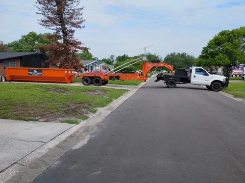Champs roll off truck on the Mims street delivering the dumpster to the home