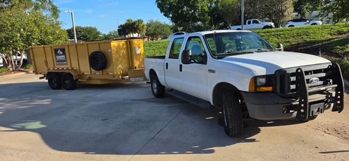 Champs truck hitched to the yellow dumpster trailer before the Winter Springs delivery