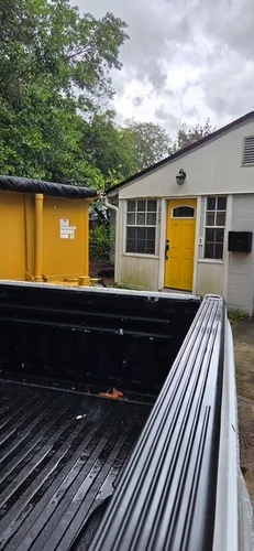 Careful driveway drop-off of the roofing dumpster at the Windermere home