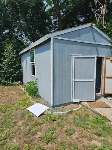 Grey backyard shed in Eustis, FL before removal