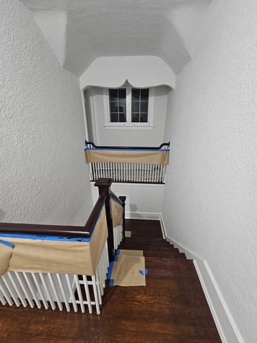 Top floor railing mid-project during the Winter Park restaining job