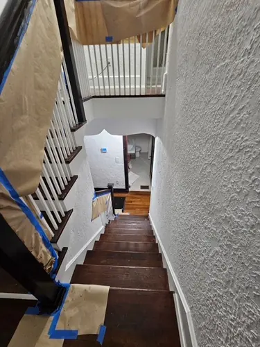 Upper banister mid-restaining with fresh stain on the rails