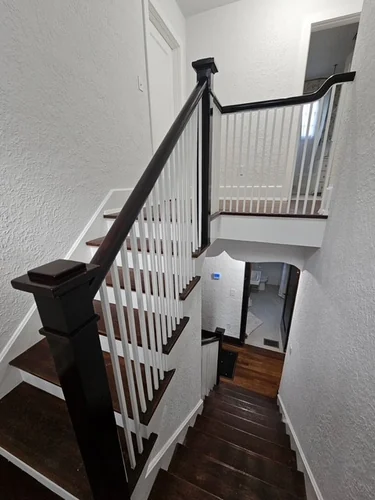 Restained staircase banister on the top floor of a Winter Park home