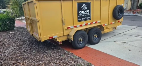 On-site Champs dumpster collecting palm fronds during the Clermont job